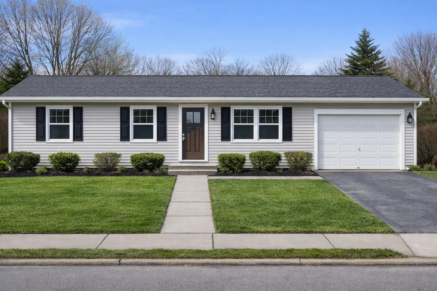 Updated ranch home exterior with new landscaping and improved curb appeal