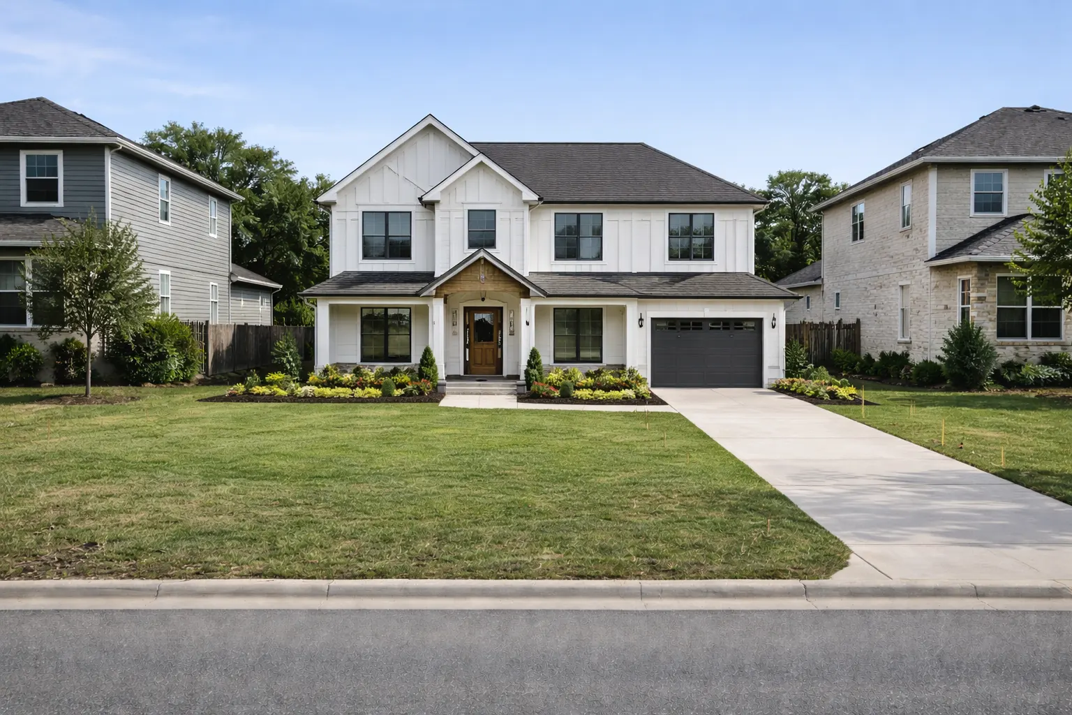 Newly built two-story home with white siding and attached garage